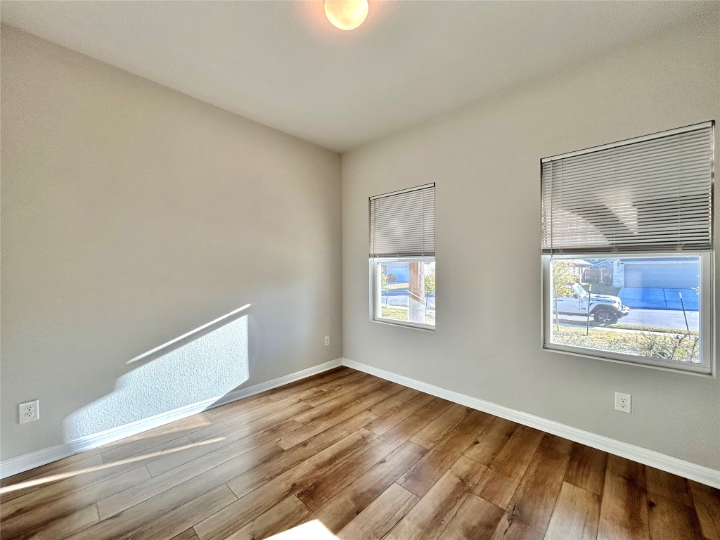 13104 Zumpango Trace Manor, TX 78653 - Photo 12 of 37 Unfurnished room with baseboards and hardwood / wood-style floors