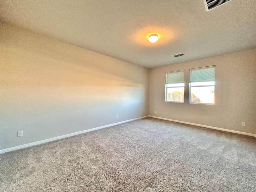 13104 Zumpango Trace Manor, TX 78653 - Photo 14 of 37 Spare room featuring a textured ceiling and carpet floors