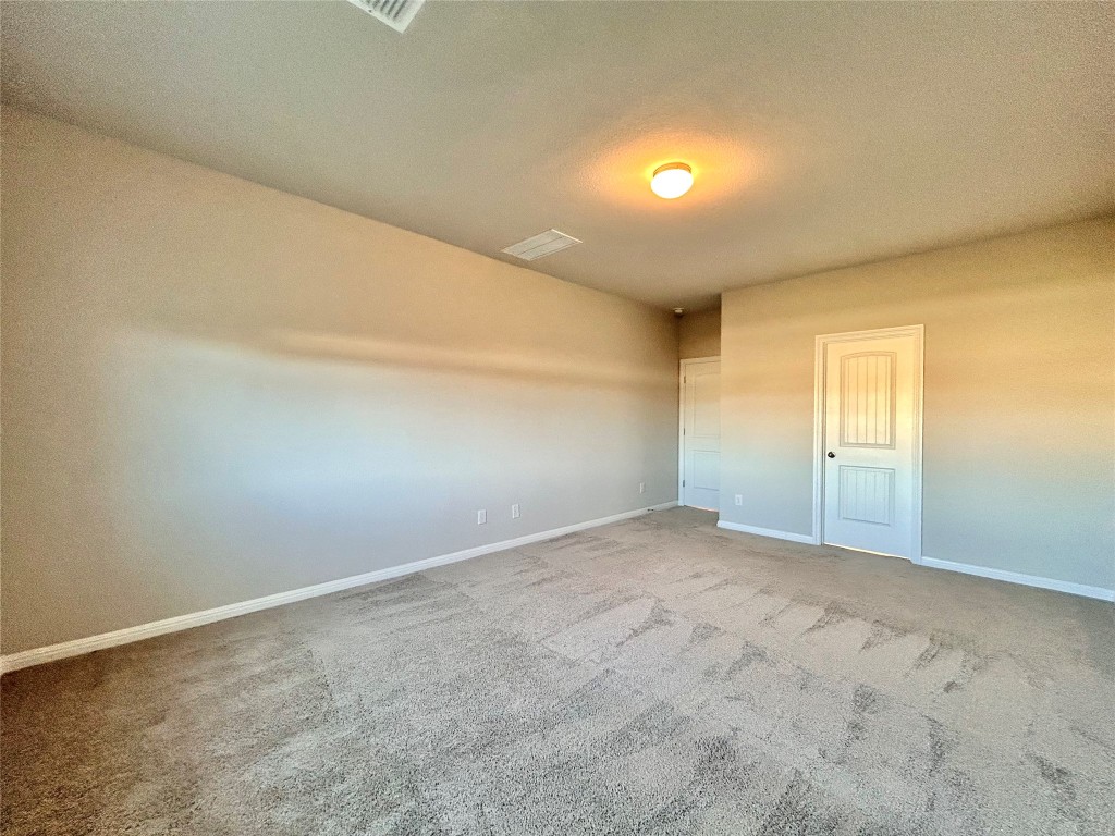 13104 Zumpango Trace Manor, TX 78653 - Photo 15 of 37 Carpeted spare room featuring a textured ceiling and baseboards