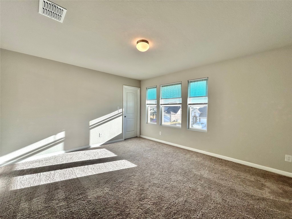 13104 Zumpango Trace Manor, TX 78653 - Photo 22 of 37 Carpeted spare room featuring baseboards