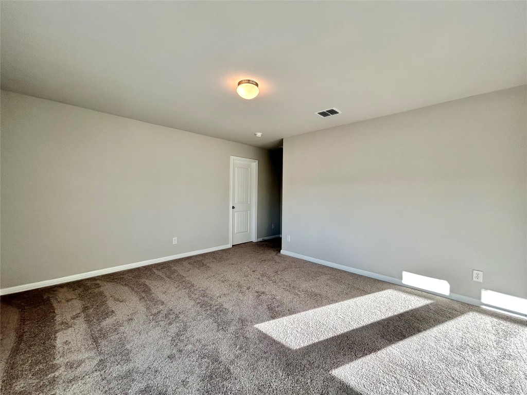 13104 Zumpango Trace Manor, TX 78653 - Photo 23 of 37 Empty room with carpet and baseboards