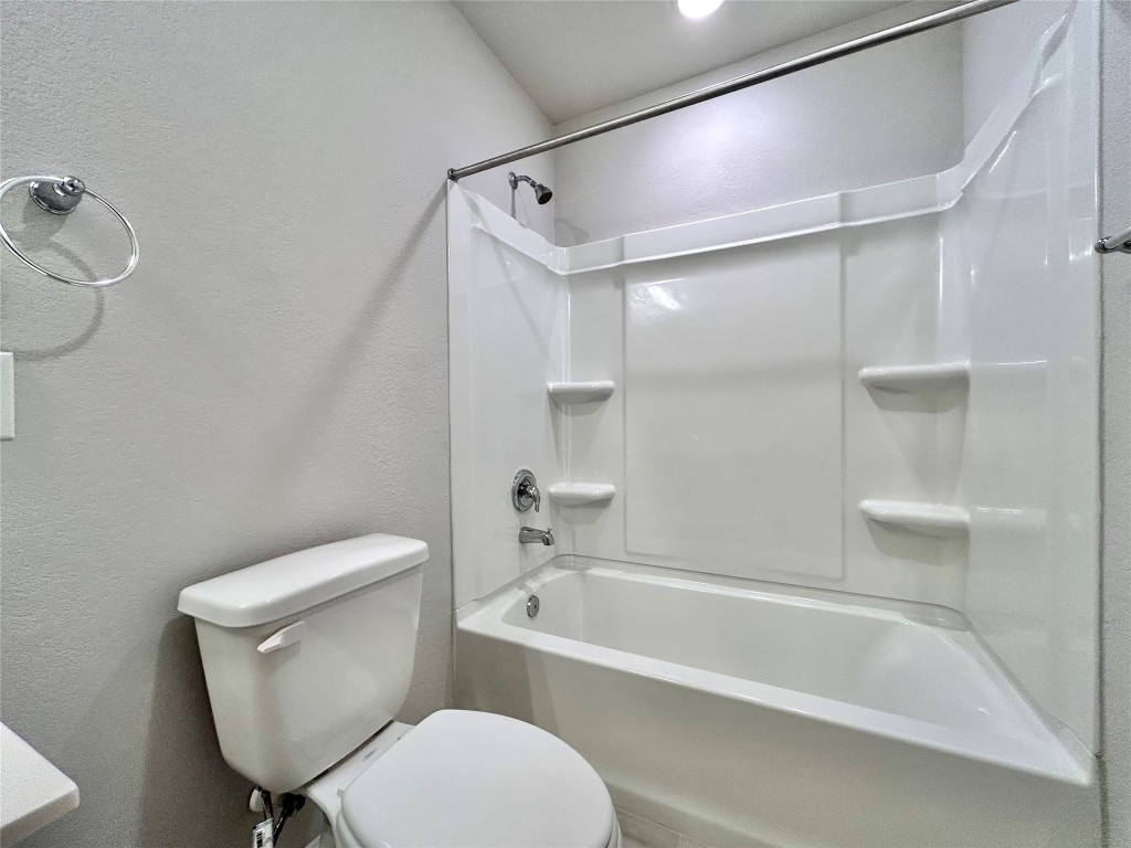 13104 Zumpango Trace Manor, TX 78653 - Photo 30 of 37 Bathroom featuring a textured wall and shower combination