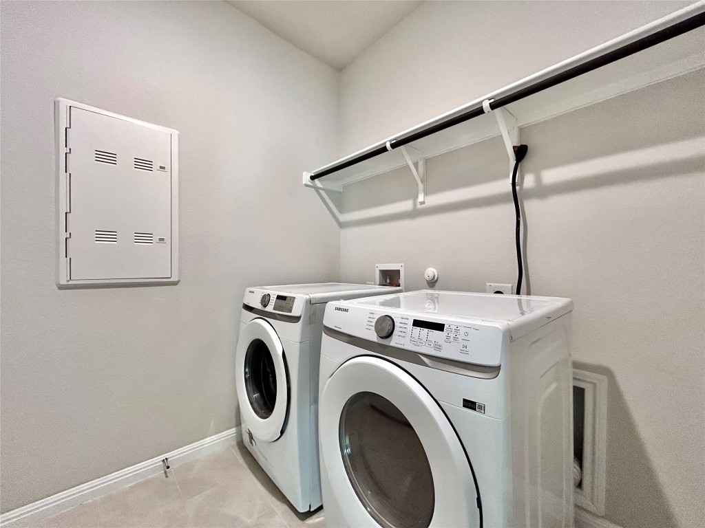 13104 Zumpango Trace Manor, TX 78653 - Photo 31 of 37 Laundry area featuring baseboards and washing machine and clothes dryer