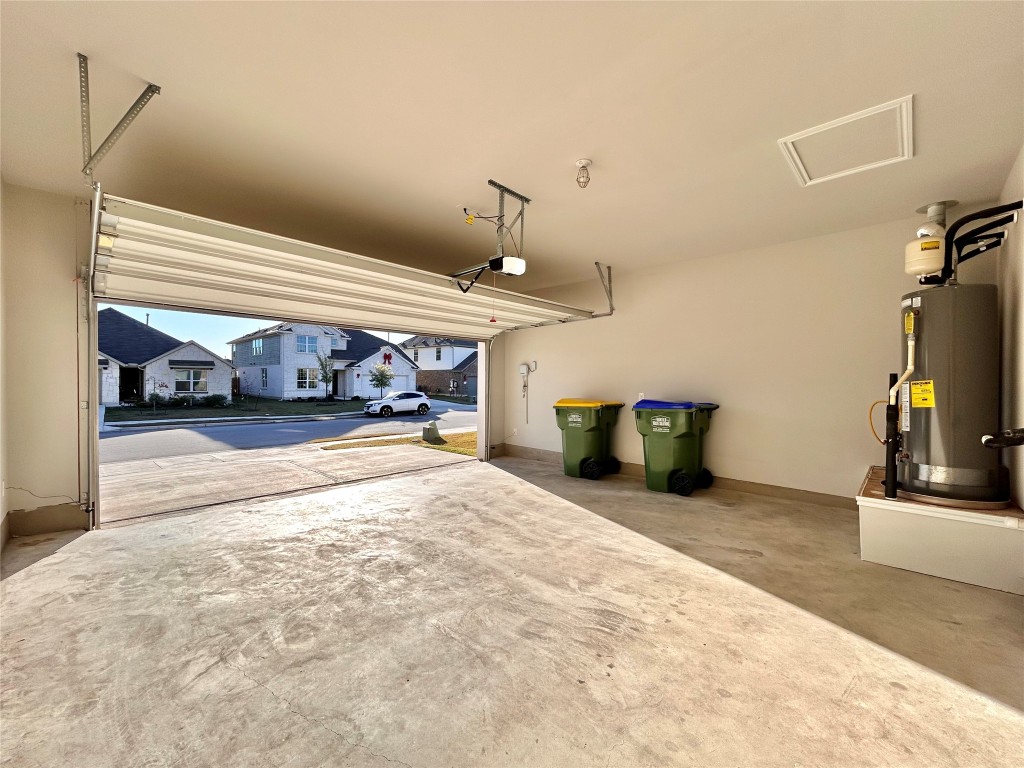 13104 Zumpango Trace Manor, TX 78653 - Photo 32 of 37 Garage featuring water heater and baseboards