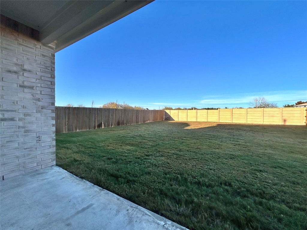 13104 Zumpango Trace Manor, TX 78653 - Photo 33 of 37 Fenced backyard with a patio area
