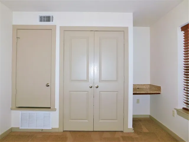 a bathroom with a granite countertop sink toilet and mirror