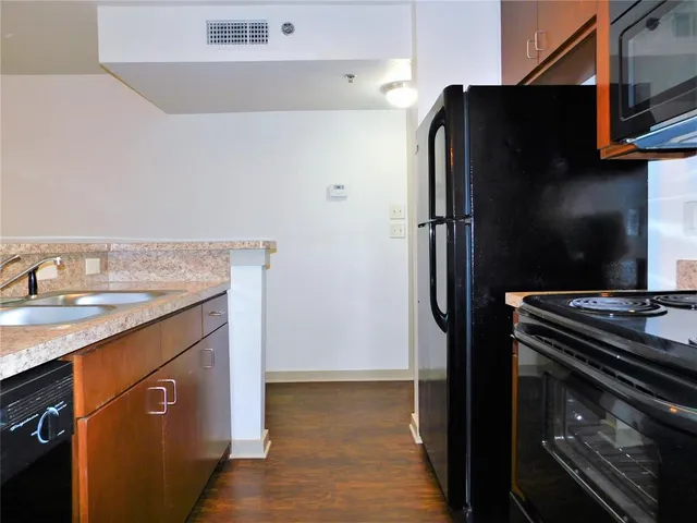 a kitchen with stainless steel appliances granite countertop a refrigerator and a sink