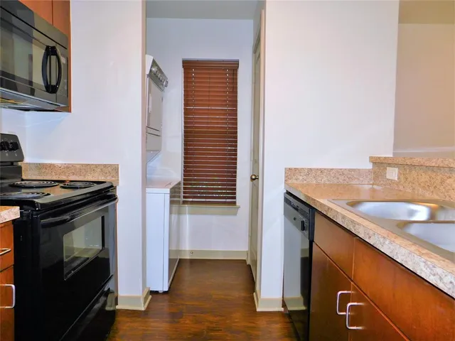 a kitchen with a sink and a stove top oven