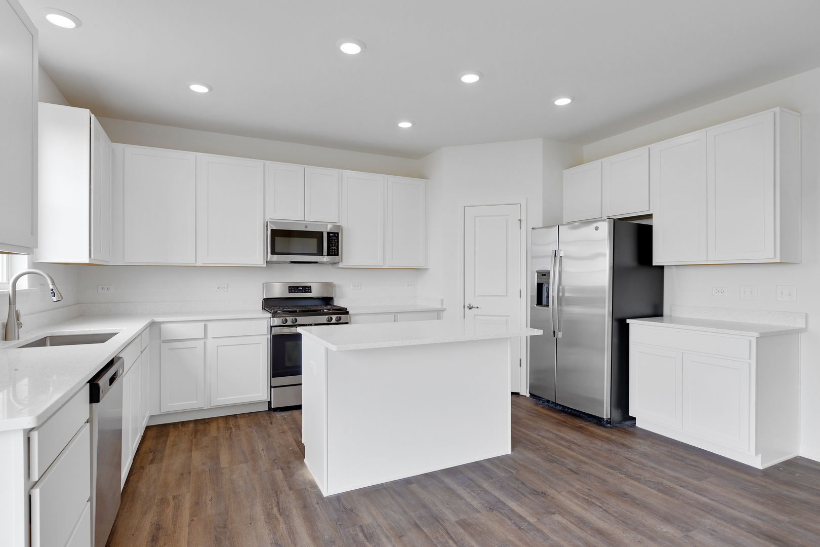 1464 Collins Street Elburn, IL 60119 - Photo 4 of 15 a kitchen with stainless steel appliances a refrigerator stove microwave and sink