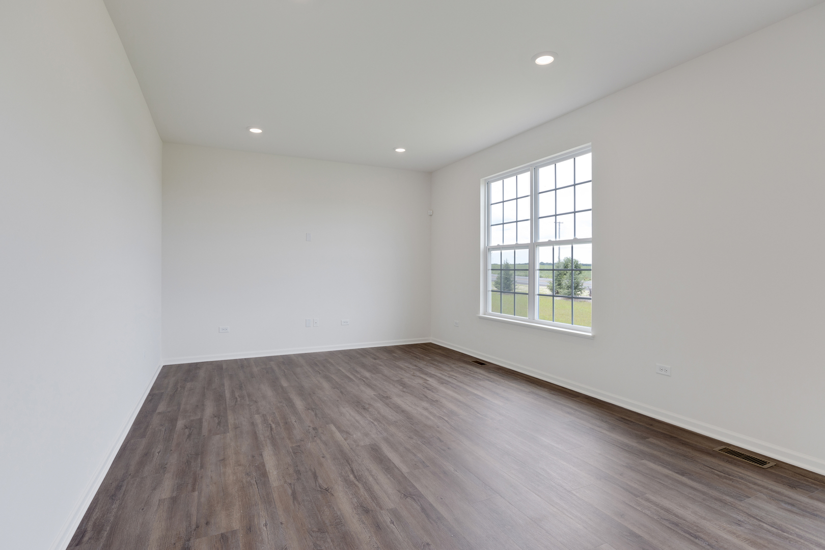 1464 Collins Street Elburn, IL 60119 - Photo 5 of 15 an empty room with wooden floor and windows