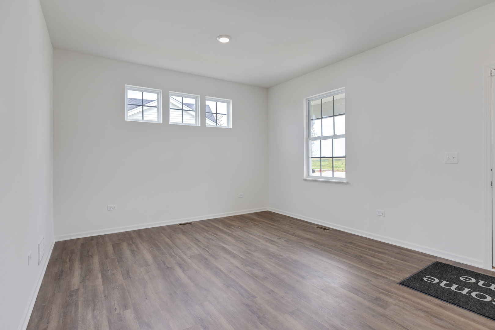 1464 Collins Street Elburn, IL 60119 - Photo 6 of 15 an empty room with wooden floor and windows