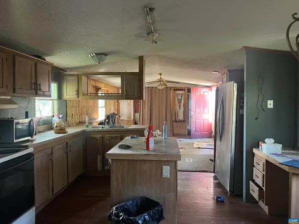 a view of a green field with wooden fence