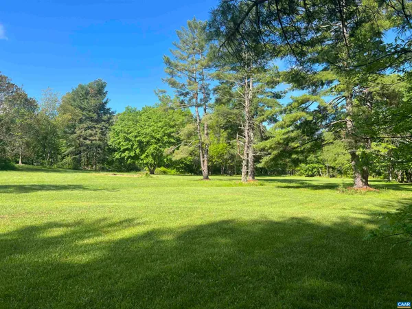 a view of a big yard with a trampoline