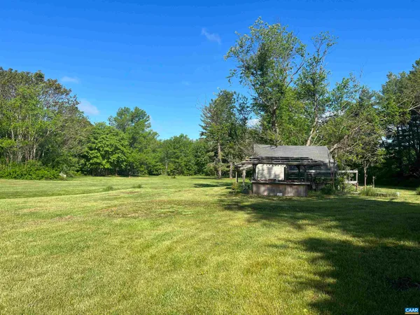 a view of a house with a yard and a patio