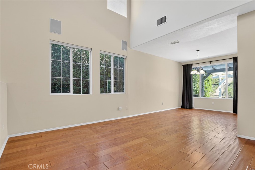 20543 Pesaro Porter Ranch Porter Ranch, CA 91326 - Photo 8 of 67 a view of an empty room with wooden floor and a window