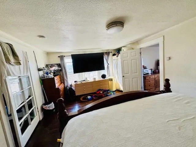 a bedroom with a bed and a flat screen tv