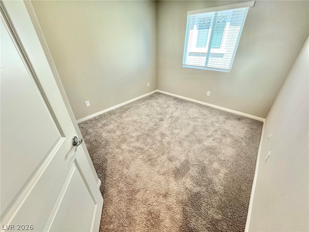 7020 Colonial Ranch Street Las Vegas, NV 89166 - Photo 15 of 37 Plush carpeting and natural light define this versatile secondary bedroom space.