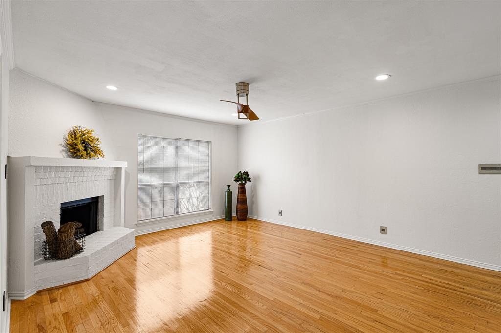 4130 Proton Drive, Unit 13A Addison, TX 75001 - Photo 14 of 40 Unfurnished living room with light wood-style flooring, a brick fireplace, recessed lighting, ornamental molding, and a ceiling fan