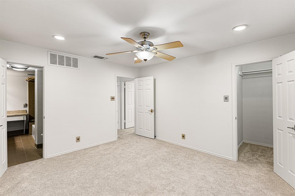 4130 Proton Drive, Unit 13A Addison, TX 75001 - Photo 22 of 40 Unfurnished bedroom featuring recessed lighting, light carpet, a ceiling fan, and a walk in closet