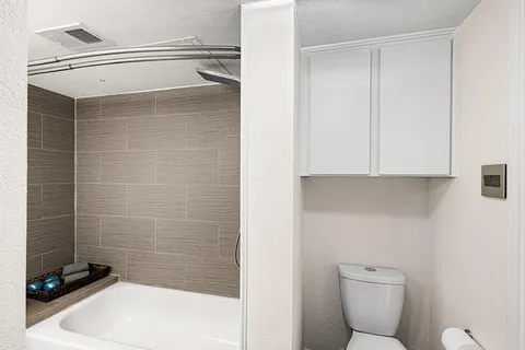 a bathroom with a toilet and a shower