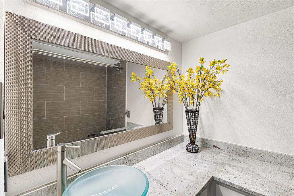 4130 Proton Drive, Unit 13A Addison, TX 75001 - Photo 24 of 40 Bathroom view of a shower, vanity, and a textured wall