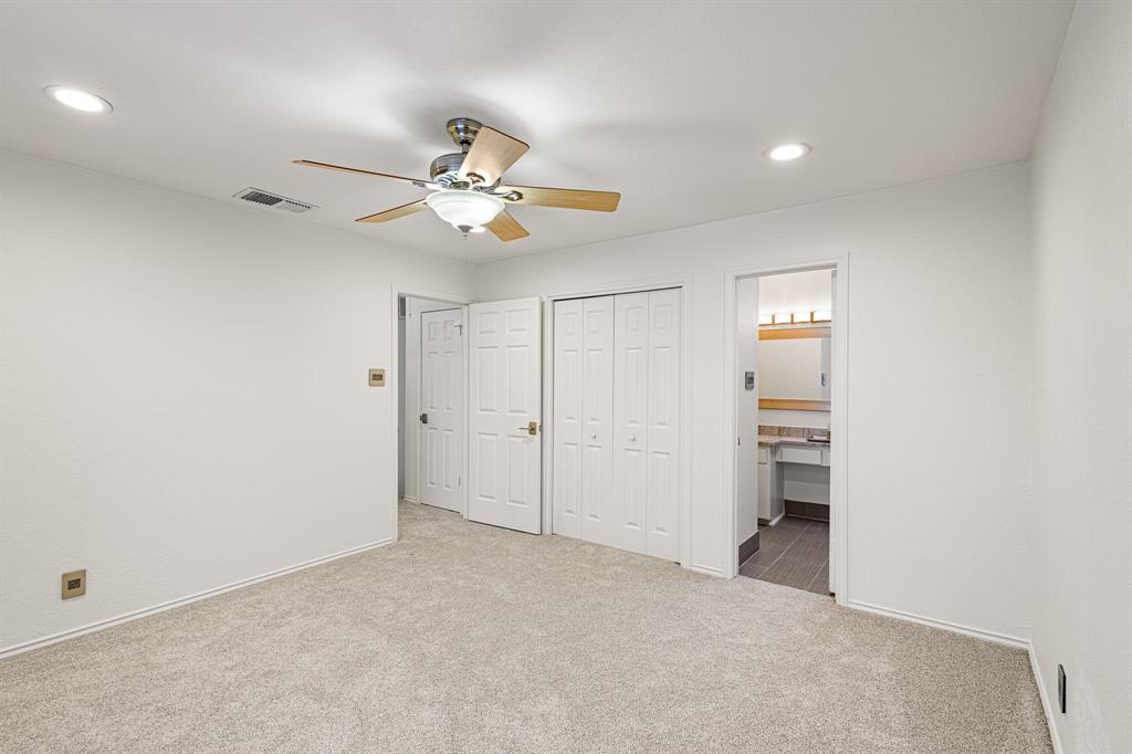 4130 Proton Drive, Unit 13A Addison, TX 75001 - Photo 26 of 40 Unfurnished bedroom with a closet, recessed lighting, light colored carpet, ceiling fan, and ensuite bathroom