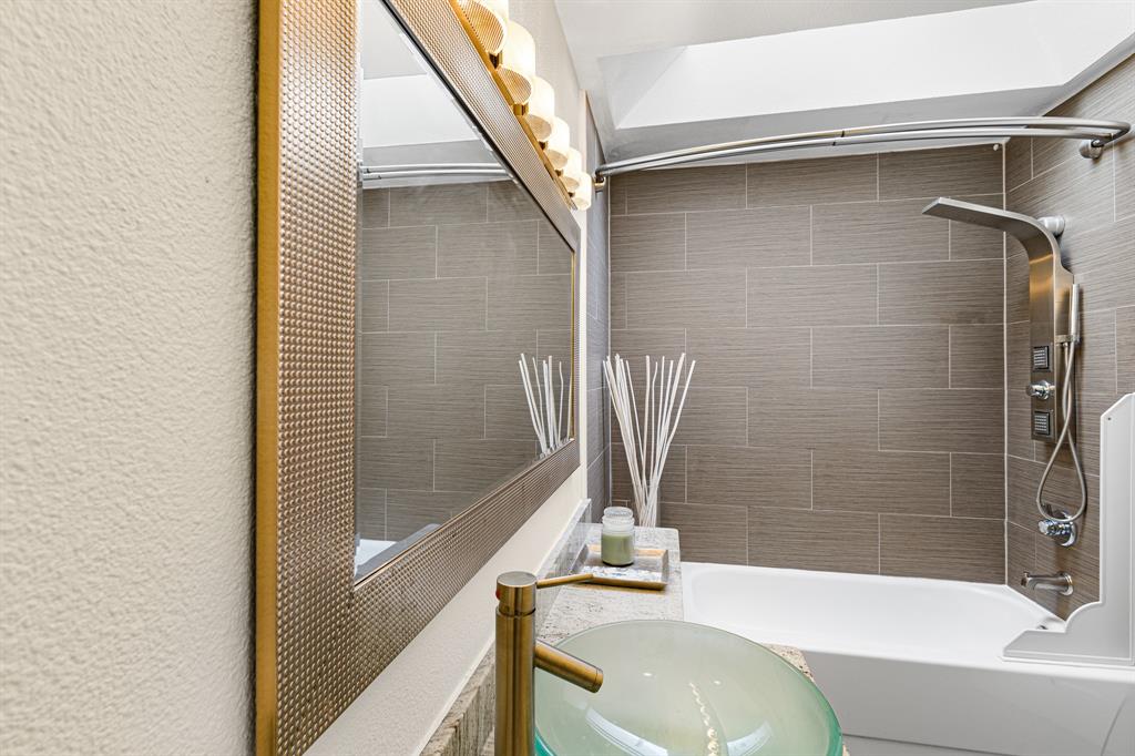 4130 Proton Drive, Unit 13A Addison, TX 75001 - Photo 28 of 40 Bathroom featuring a textured wall, shower combination, and vanity