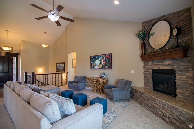 646 East 1400th Street North Mapleton, UT 84664 - Photo 11 of 78 Spacious living area featuring a stone-clad fireplace with a granite hearth, vaulted ceilings, and recessed lighting