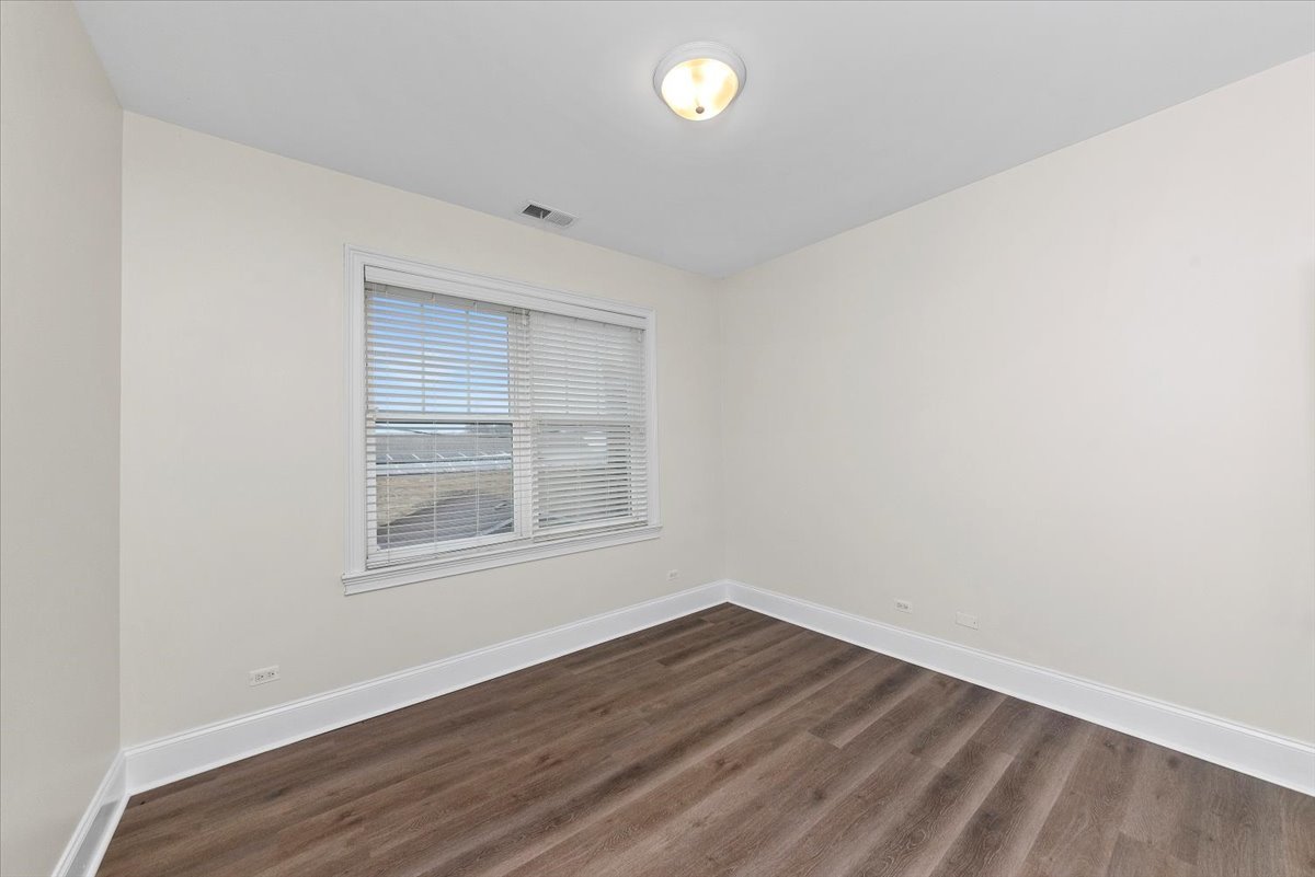 2500 Green Bay Road, Unit 403 Evanston, IL 60201 - Photo 13 of 16 an empty room with wooden floor and windows