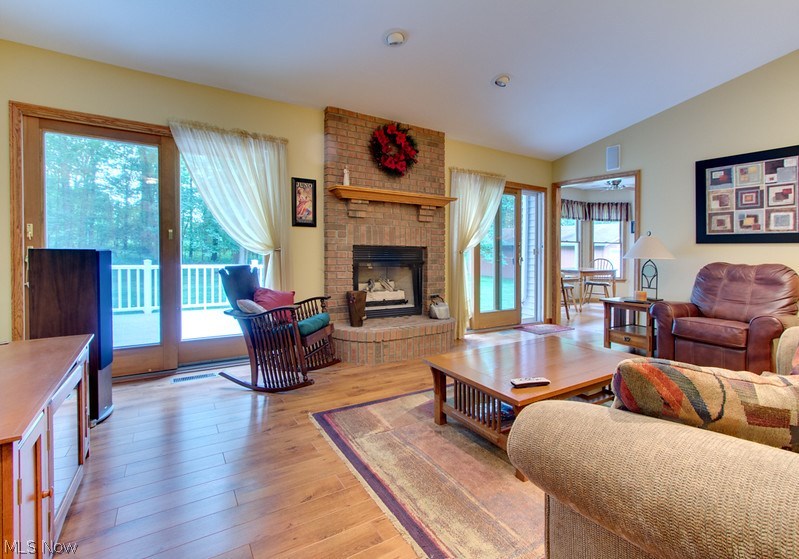 4675 Richman Road Litchfield, OH 44253 - Photo 2 of 30 Bright and beautiful family room overlooks the backyard and accesses the deck via two sliding patio doors. This room also features new laminate flooring and a brick fireplace.