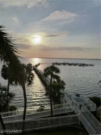 a sunset view with a lake