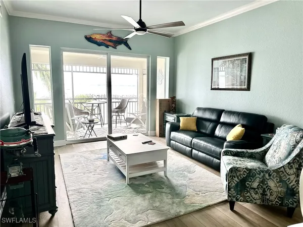 a view of a dining room with furniture a chandelier and wooden floor