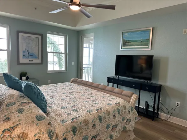 a bedroom with a large bed and a tv
