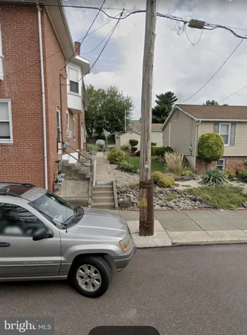 a view of a backyard with table and chairs