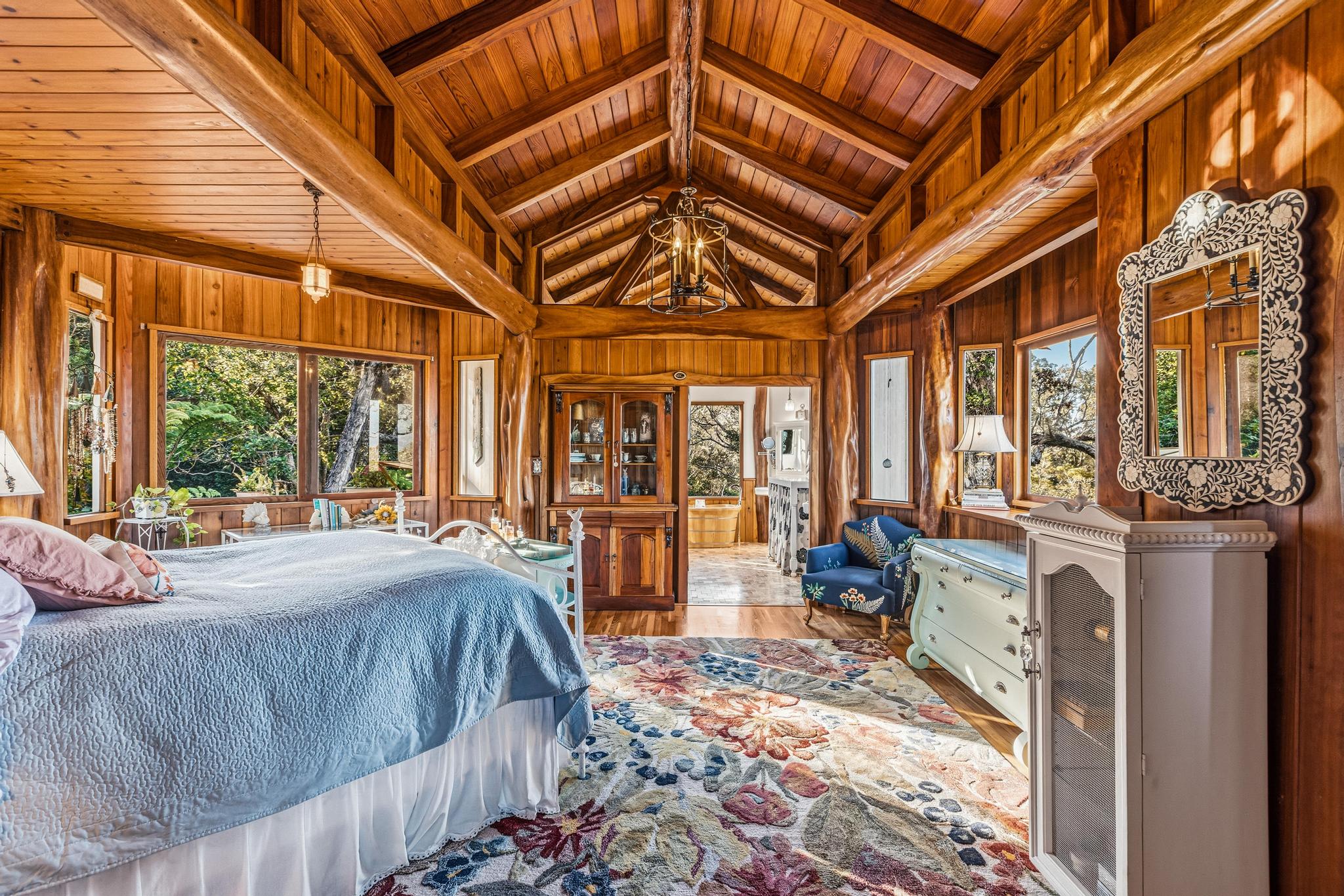 43-5745 Old Stable Road Paauilo, HI 96776 - Photo 21 of 30 a spacious bedroom with a bed and wooden floor