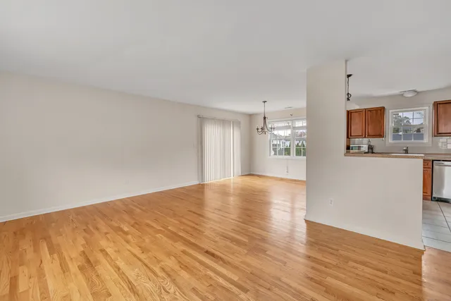 a view of a kitchen with wooden floor and a kitchen