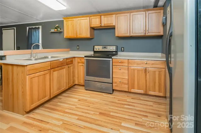 a kitchen with stainless steel appliances granite countertop a sink and cabinets