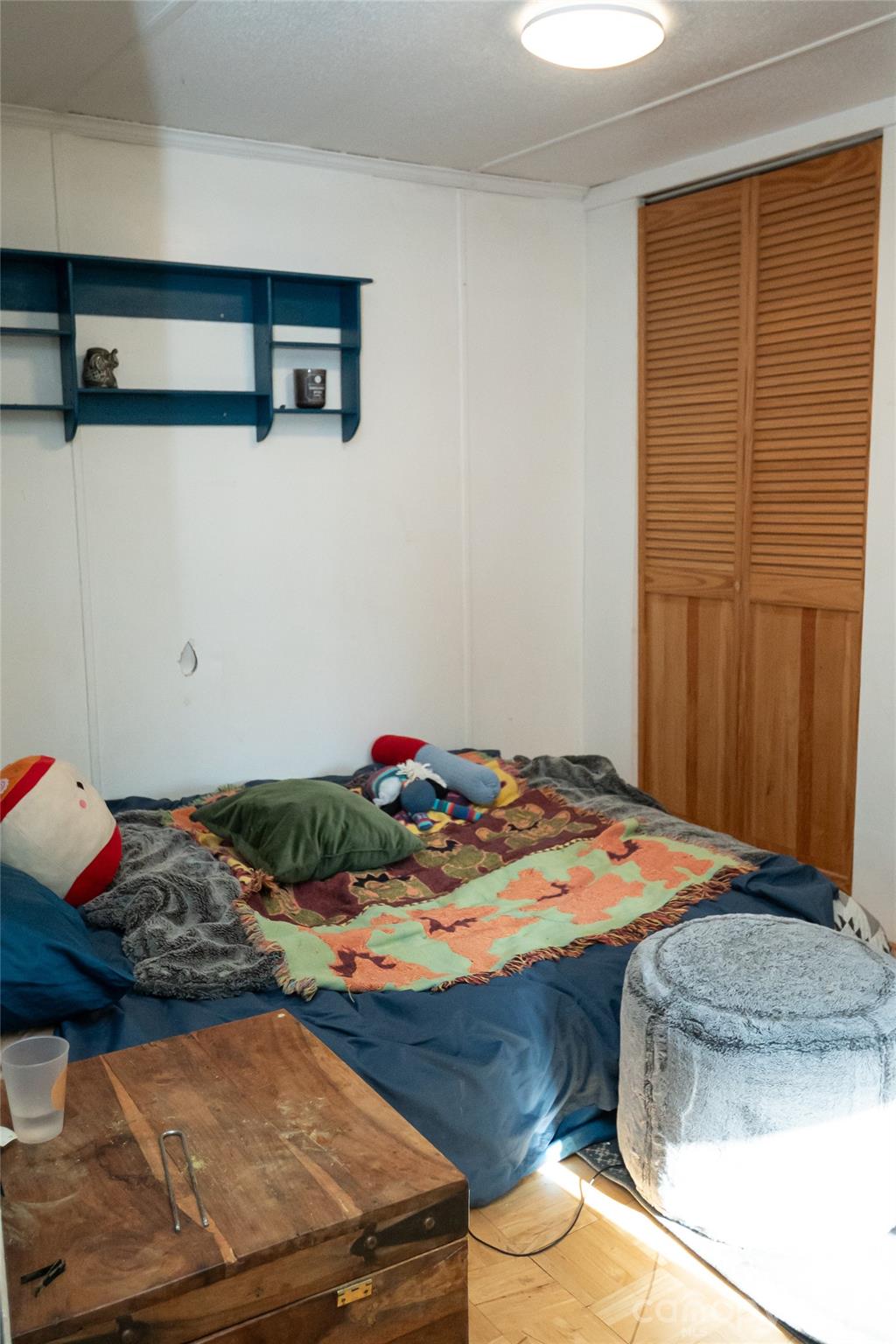 910 Summit Ridge Road Purlear, NC 28665 - Photo 19 of 25 a bedroom with a bed and a closet