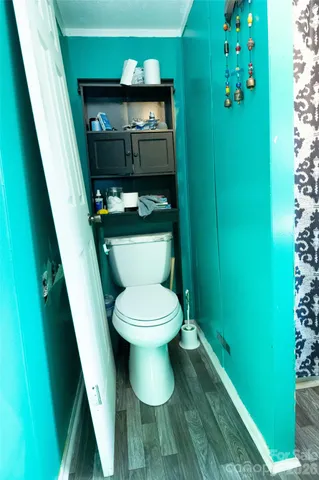 a bed room with furniture a rug and a window