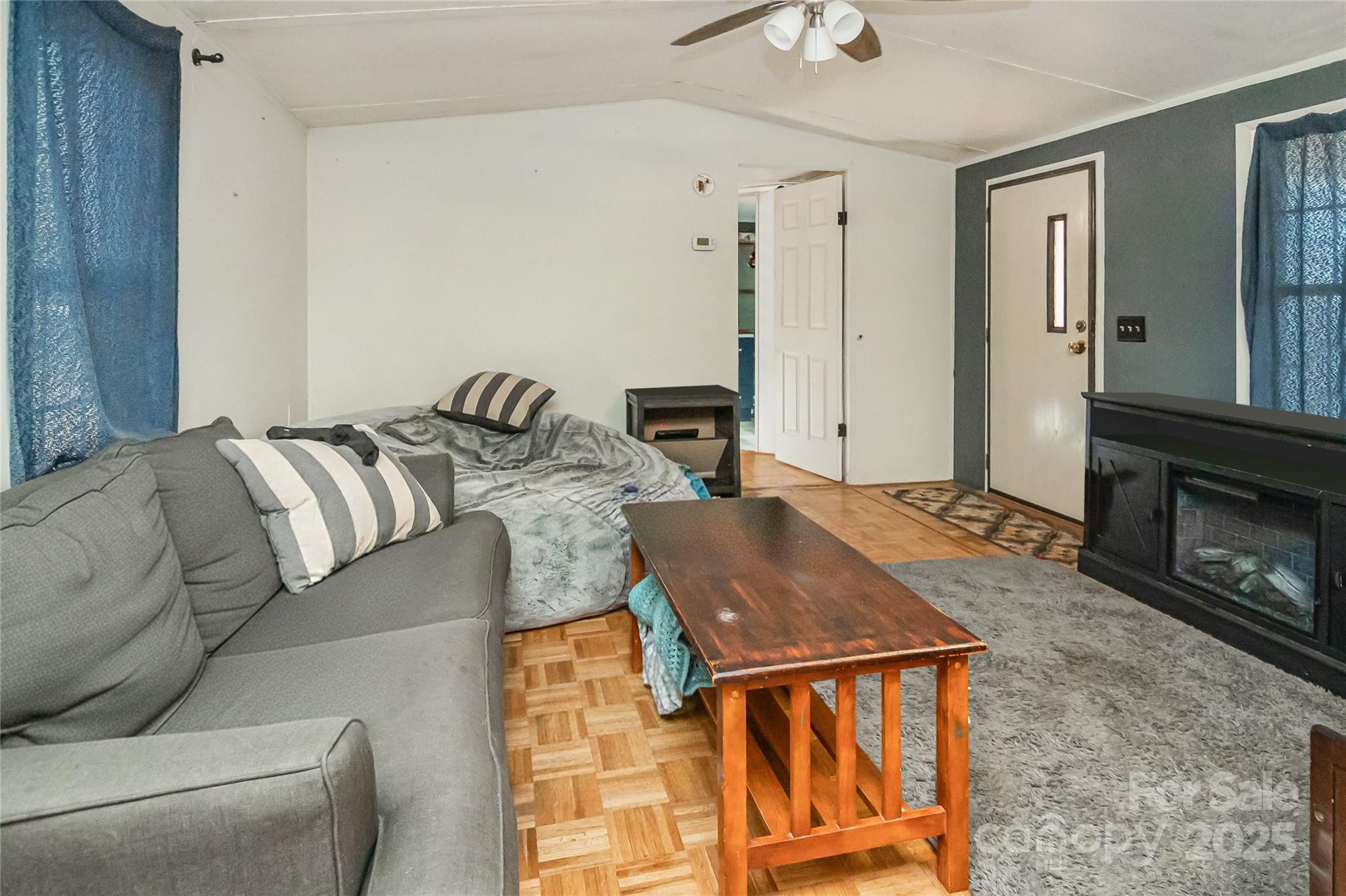 910 Summit Ridge Road Purlear, NC 28665 - Photo 3 of 28 a living room with furniture a flat screen tv and a fireplace
