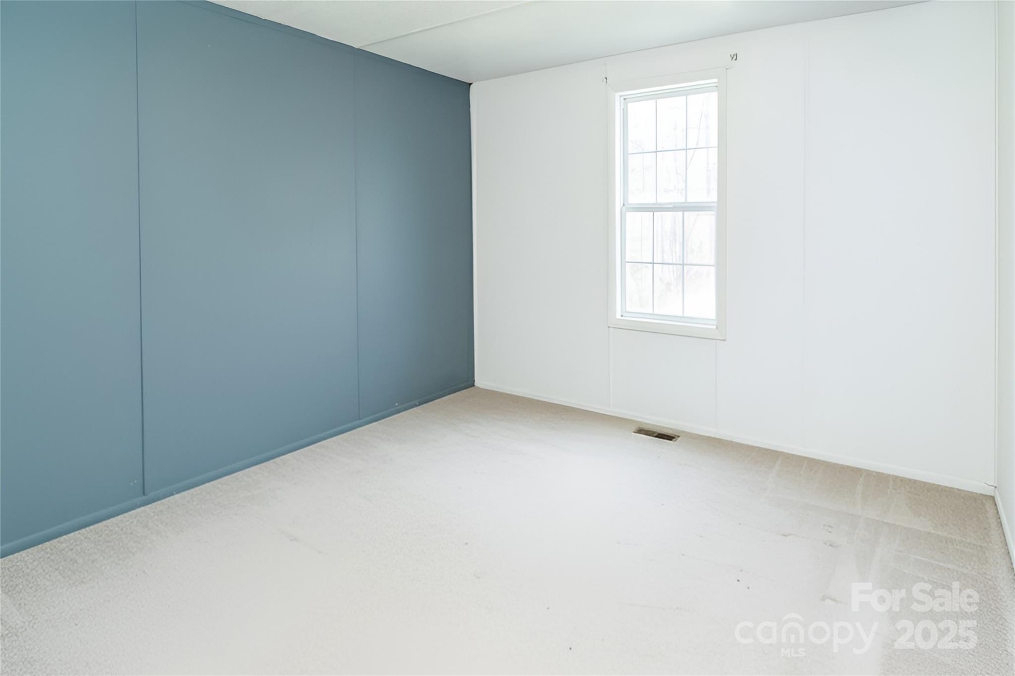 910 Summit Ridge Road Purlear, NC 28665 - Photo 5 of 28 an empty room with a window