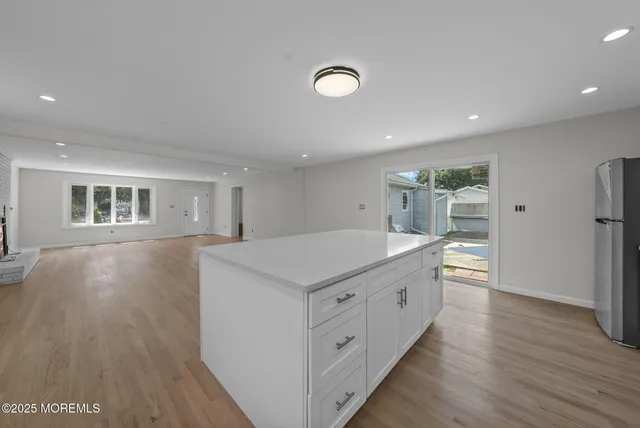 a kitchen with sink and wooden floor