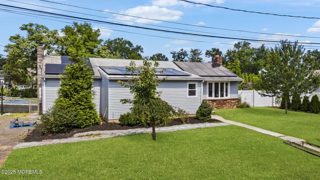 a front view of a house with a garden