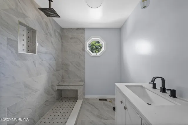 a bathroom with a sink a toilet and a window