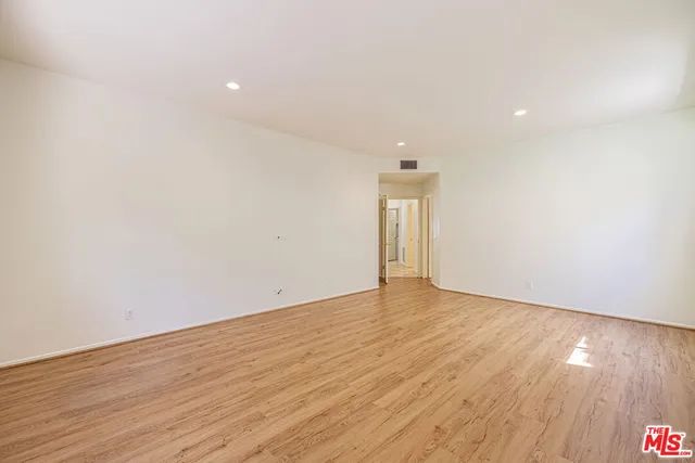 a bedroom with a large bed and a flat screen tv