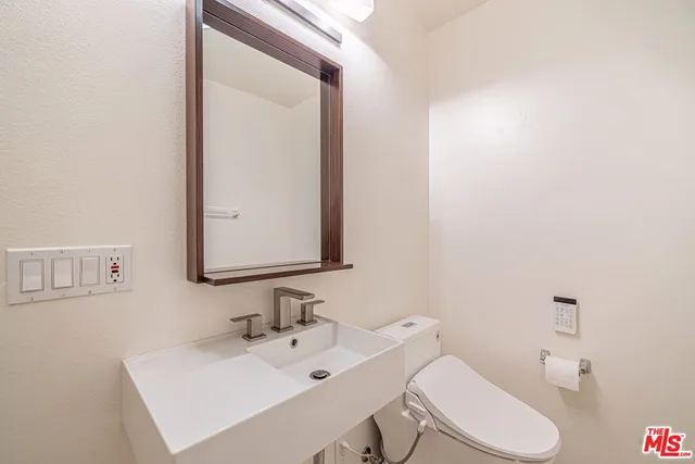 a bathroom with a sink double vanity and a mirror