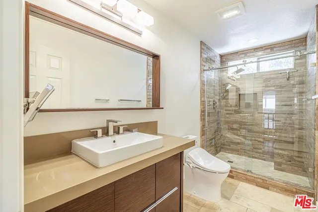 a bathroom with a sink a vanity and a mirror