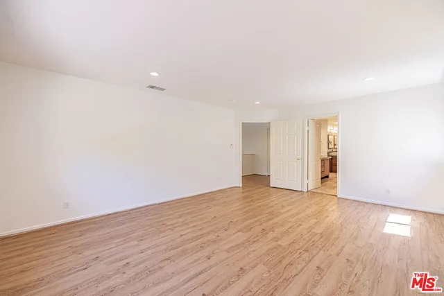 a vase of flowers sitting on a table in front of a house
