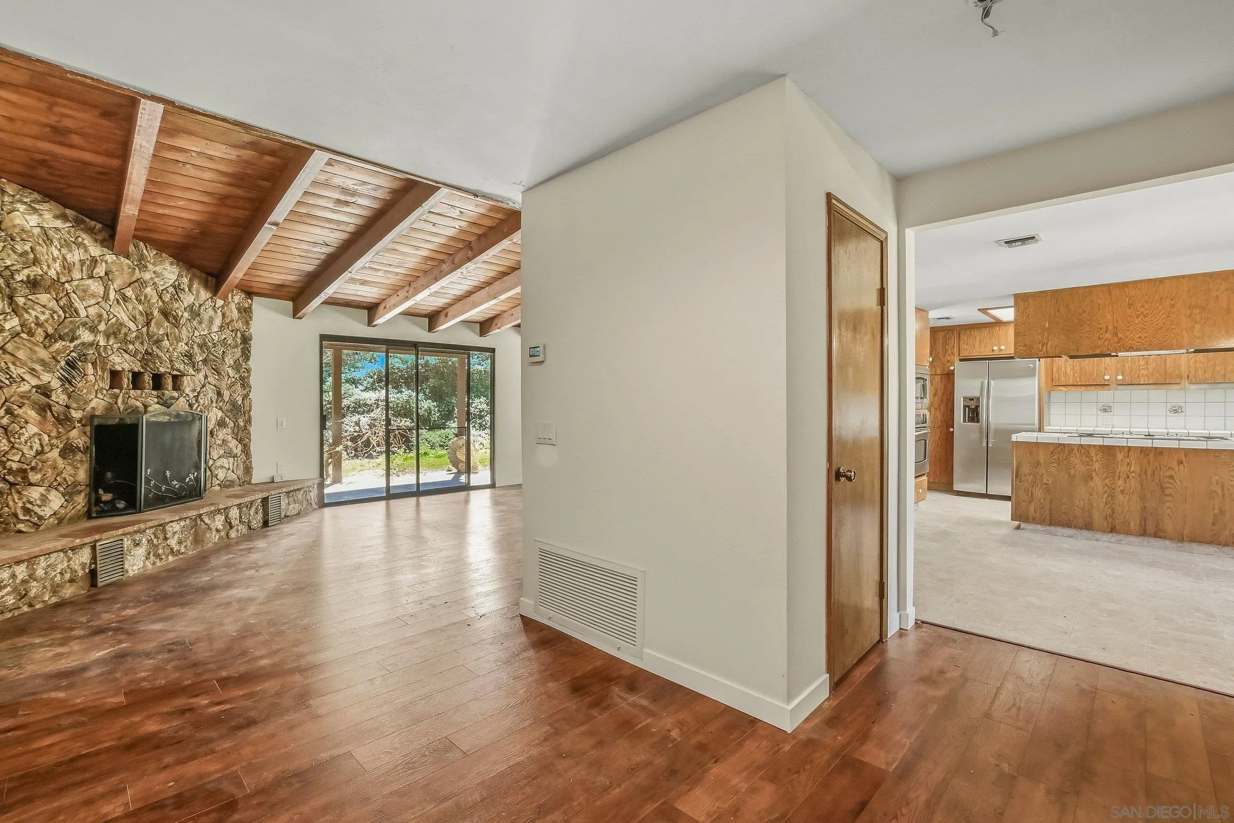 9907 Anderson Ranch Road Descanso, CA 91916 - Photo 7 of 42 a view of a hallway with wooden floor and a living room