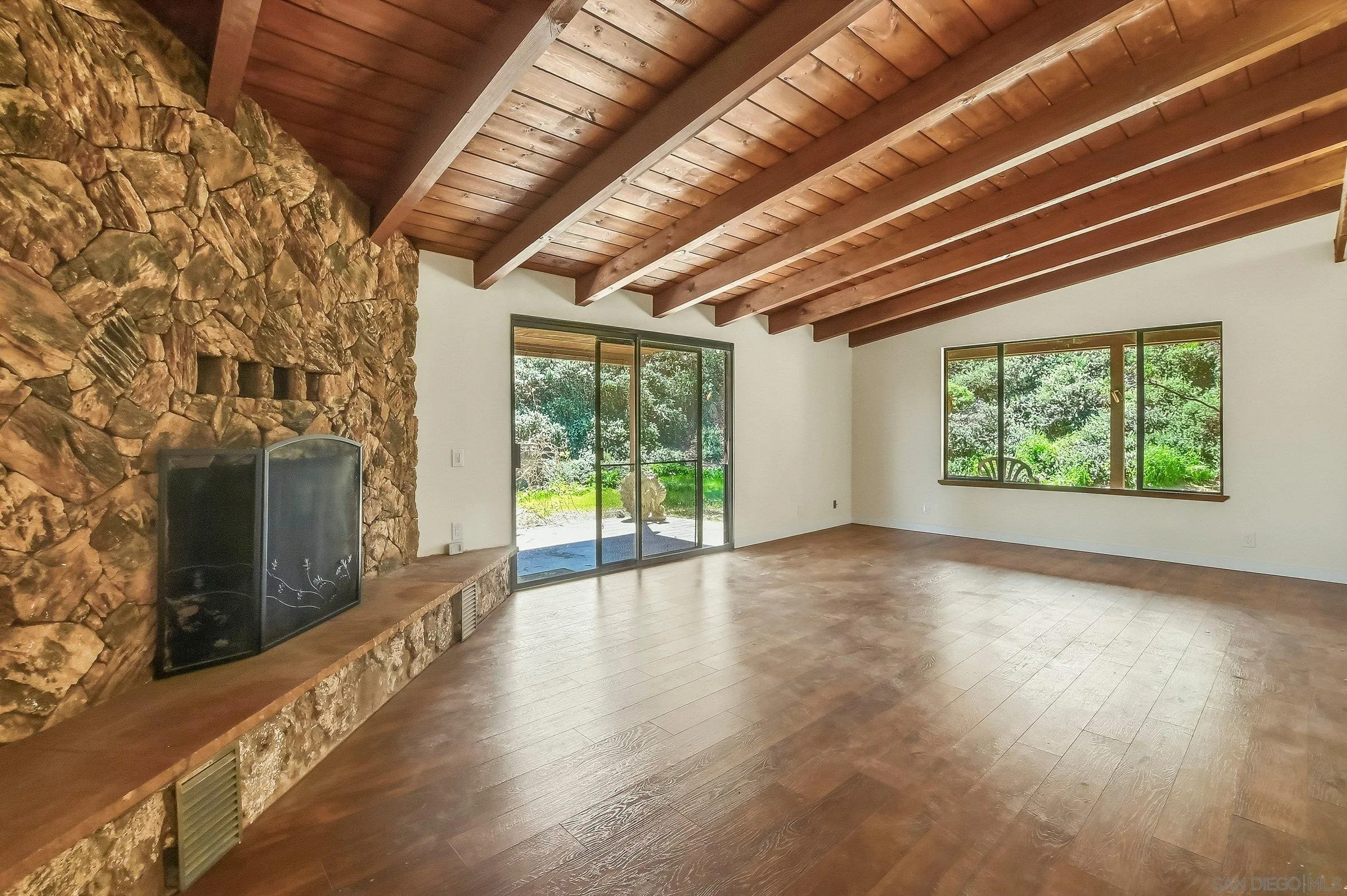 9907 Anderson Ranch Road Descanso, CA 91916 - Photo 8 of 42 a view of an empty room with wooden floor and a fireplace